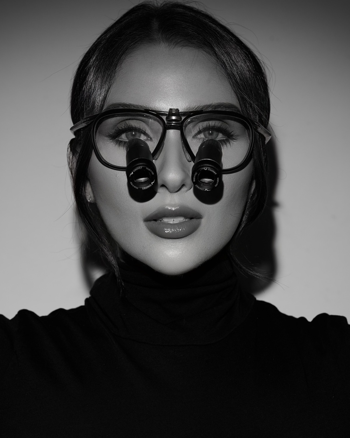 Dr. Melanie Silvestrini, symmetrical portrait in surgical loupes