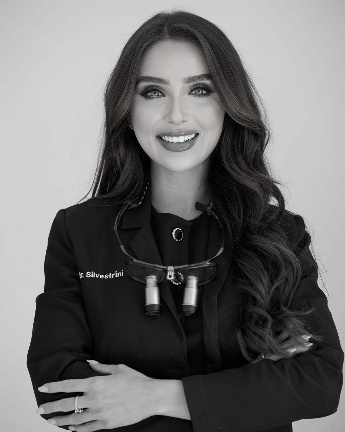 Dr. Melanie Silvestrini, portrait with clinical loupes